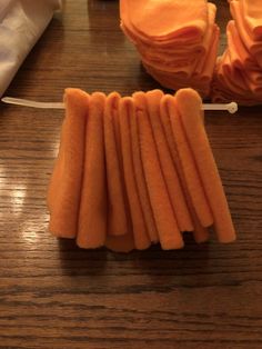 sliced carrots are arranged on a wooden table