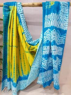 two blue and yellow scarves hanging on a clothes line