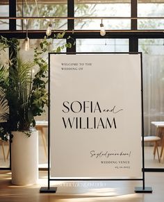 a sign that says sofia and william on it in front of some potted plants