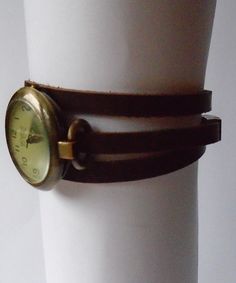 This is a wrap style watch. The case is bronze color metal alloy, free of nickel and lead, round 1.25 inches diameter. The quadrant is vintage style, greenish cream color with numerals. The bracelet will be custom made in crazy-horse distressed finish brown leather 6mm wide. Choose the measure of your wrist and the bracelet will be made with a length 3 times your wrist plus 3/4 inch for room. The closure is a magnetic clasp also made in bronze finish metal alloy. free of nickel and lead. The sty Adjustable Brown Wrist Strap Watch Accessories, Adjustable Brown Steampunk Watch Accessories, Brown Cuff Bracelet Strap Watches, Vintage Brown Wrist Strap For Watches, Distressed Brown Leather Watch Strap, Watch For Women, Style Watch, Women's Watches, Crazy Horse