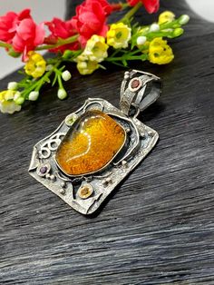 "Artisan Amber gemstone pendant Hand-made Sterling Silver. Stones used: Amber, Peridot, Amethyst, Garnet, Citrine. Height - 51mm, Width - 34mm. Unique Handcrafted One-of a-kind Design Pendant Each Piece of Jewelry in my Collection is Absolutely One of a Kind! When you start wearing a piece of my jewelry you will fall in love with it more and more each day and feel that good Energy and Love that I pass into it while creating this piece of Art. A piece of Art created for you to be inspired and lov Amber Large Pendant Jewelry As Gift, Rectangular Amber Jewelry Gift, Fusion Style Jewelry With Natural Stones For Gifts, Fusion Style Natural Stone Jewelry For Gifts, Fusion Style Natural Stone Jewelry Gift, Handmade Citrine Pendant Jewelry, Artistic Handmade Jewelry With Square Pendant, Yellow Gemstone Fusion Jewelry, Fusion Style Oval Pendant Necklace For Gift