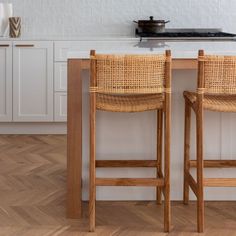 two wooden chairs sitting on top of a kitchen counter