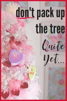 a pink christmas tree decorated with hearts and saying don't pack up the tree quite yet