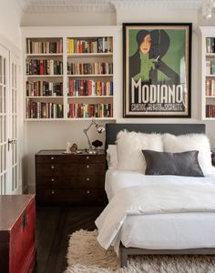 a bedroom with bookshelves and a bed in it