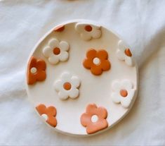 a white plate with orange and white flowers on it