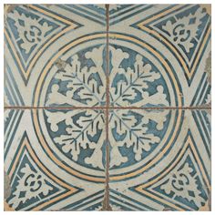 a blue and white tile with an intricate design on the bottom, surrounded by smaller tiles