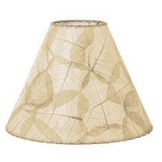 a lamp shade that has leaves on it