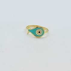 An elegant 14k yellow gold ring with a sweet enamel fish pattern in baby blue, white and black colors. Fish is a symbol of courage, our ability to achieve high goals and overcome life's difficulties. Ring size: 52 FR. That fish smalti ring with evil eye can be made in our workshop at any size desired. A yellow gold 14k ring, can be combined easily with your other jewelry on your everyday life. Elaborately made enamel colorful fish on a solid gold ring, it comes with an elegant jewelry box and gi 14k Yellow Gold Enamel Ring Gift, Enamel Yellow Gold Rings For Gift, Yellow Gold Enamel Rings For Gifts, Adjustable Yellow Gold Enamel Ring Gift, Green 14k Gold Enamel Ring As Gift, Green Enamel 14k Gold Ring Gift, Yellow Gold Evil Eye Rings As Gifts, Symbolic Gold Enamel Ring As Gift, Enamel Fish-shaped Jewelry As Gift