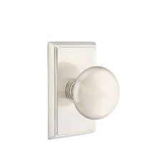 an image of a white door knob on a wall mounted light switch in the shape of a ball