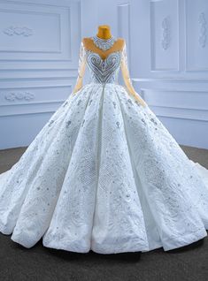 a white and gold wedding gown on display