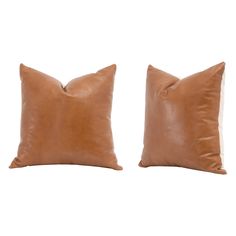 two brown leather pillows sitting next to each other