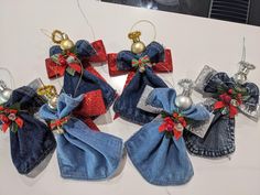 four denim christmas ornaments with bows and bells