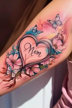 a woman's arm with flowers and butterflies on it, the word mom is written in