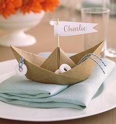 a paper boat with a name on it