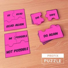 four pieces of pink puzzle sitting on top of a wooden table