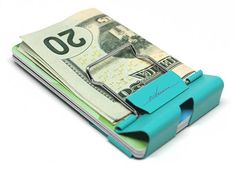 the money clip is made out of paper and has a blue rubber holder on it