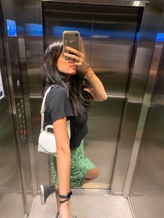 a woman taking a selfie in an elevator