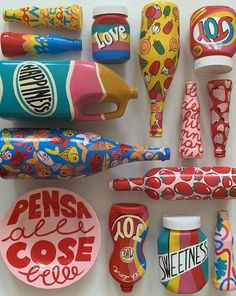 various types of candy and toothbrushes are arranged on a white surface with the words pens & cose below them