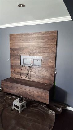 an electrical device is sitting on top of a piece of wood in the middle of a room