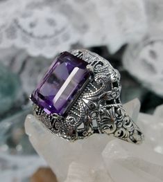 Natural Purple Amethyst Ring Intricate Design#149 Custom Made Inspired by Victorian era designs, I now offer this lovely filigree reproduction in sterling silver. This is a flawless natural purple amethyst is 12mm by 10mm in Length & Width. The ring is 3/4th of an inch North/South on the finger. The inside of the band is etched 925. Notice the intricate and detailed Victorian design of the antique patina silver filigree setting all the way down the band. This is an exquisite rendition of an Purple Amethyst Ring With Intricate Design For Promise, Purple Amethyst Ring With Intricate Design, Purple Amethyst Promise Ring With Intricate Design, Purple Promise Ring With Intricate Design, Purple Intricate Design Promise Ring, Purple Anniversary Rings With Intricate Design, Antique Purple Amethyst Ring With Accent Stones, Ornate Amethyst Gemstone Ring, Ornate Amethyst Purple Ring