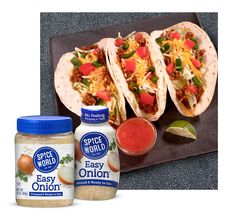 three tacos and two condiments are on a plate with the same product