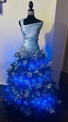 a blue christmas tree with snowflakes on it