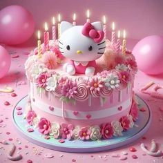 a hello kitty birthday cake with pink flowers and candles