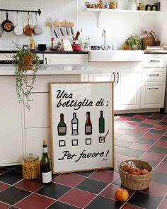 a kitchen with red tile floors and white cabinets has a poster on the counter that says wine, vegeta di per favore