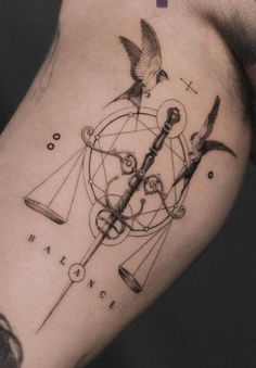 a man's arm with a tattoo on it that has birds flying around the clock