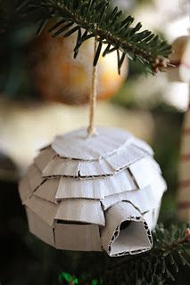 an ornament hanging from a christmas tree with some paper on it's side