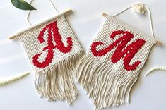 two red and white wall hangings with monogrammed letters