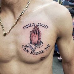 a man's chest with a tattoo saying only god can judge me