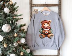 Christmas Bear Sweatshirt, Teddy Bear Hoodie, Cute Christmas Gift, Xmas Teddy Bear Sweater, Christmas Season Apparel, Xmas Toy Sweatshirt CAUTION: For security reasons, there is no rope in the throat area for youth hoodie. Hello!! We wish everyone to smile with our cute, stylish, and trendy graphic sweatshirts and hoodies. We assure you these sweatshirts and hoodies are the perfect gifts whether you buy them for yourself or someone else.  This is not Combo Listing  1. Important Check size chart before you purchase. 2. How to Order *Pick your shirt type and size Your design will be printed on the front.  *Pick your shirt color. 3. Production  Processing time is 1-3 business days. For rush orders please contact us first.  4. Shipping Domestic Shipping First Class 2-5 Business days Priority M Winter Gift Hooded Sweatshirt, Hooded Winter Sweatshirt Gift, Cozy Winter Sweater For Gift, Cozy Winter Sweater Gift, Cozy Winter Sweater As Gift, Cute Winter Sweatshirt For Gift, Cute Winter Sweatshirt Gift, Cute Winter Holiday Sweatshirt, Cute Sweatshirt For Holiday Winter