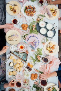 people sitting at a table with food on it