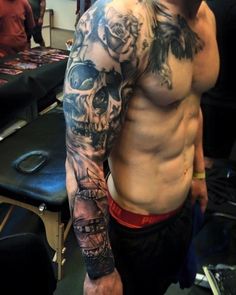 a man with tattoos on his arm and chest