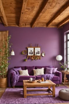 a living room with purple walls and wooden beams on the ceiling is decorated in natural wood