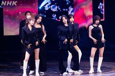 the group of girls are performing on stage