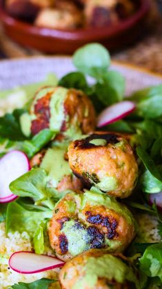 some food is on a plate with greens and radishes