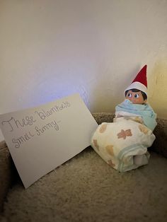 an elf with a sign on the floor