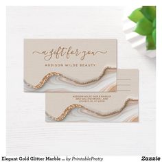 two business cards with gold foil on them