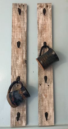 two pieces of wood that have been made into hooks on the side of a wall