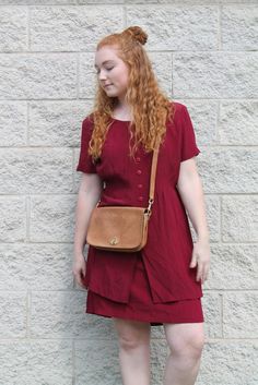 We love this short sleeve button up maroon dress! It's perfect for a casual day look but can also be dressed up! It hits just above the knees and has a layered look on the bottom of the dress.  Brand: City Lights Size: 8p Measurements (taken flat): Bust: 39" Waist: 33" Length: 44" Sleeve: 8.5" Shoulder: 16.5" Condition: Excellent Vintage Condition *Please keep in mind our items are previously loved vintage goods and may have some small flaws. We do our best to make shoppers aware of any spots, stains, or tears. Measurements are taken flat and in inches. Please remember that vintage tag sizes are often unreliable and it is best to judge sizes by the measurements provided. All sales are final. Sorry, no returns or exchanges. Please message us if you have any questions about an item, we'd lov Short Sleeve Everyday Fall Dresses, Everyday Short Sleeve Fall Dresses, Casual Burgundy Short Sleeve Dress, Maroon Dress, Vintage Button, Short Sleeve Button Up, Layered Look, Chicago Il, City Lights