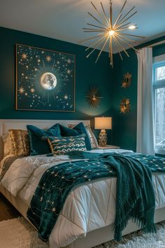 a bedroom decorated in teal, gold and white with a large starburst hanging above the bed