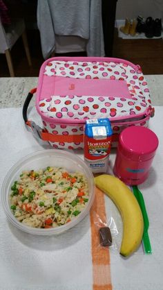 the lunch box is filled with rice, vegetables and fruit