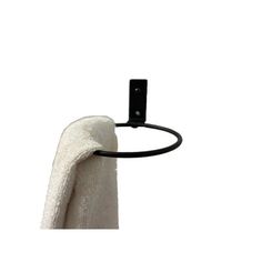 a black towel ring hanging from the side of a white towel holder on a wall