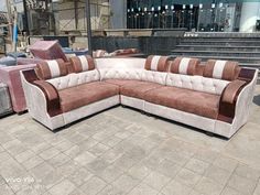 a large sectional couch sitting on top of a sidewalk