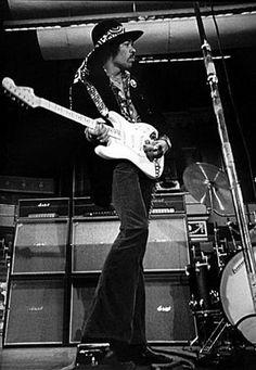 a black and white photo of a man playing guitar