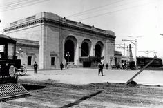 an old black and white photo of people in front of a train station