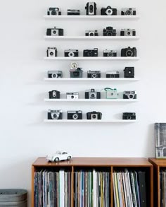 the wall is filled with shelves full of movies and video tape recorders, as well as various records