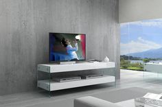 a flat screen tv sitting on top of a white entertainment center in a living room